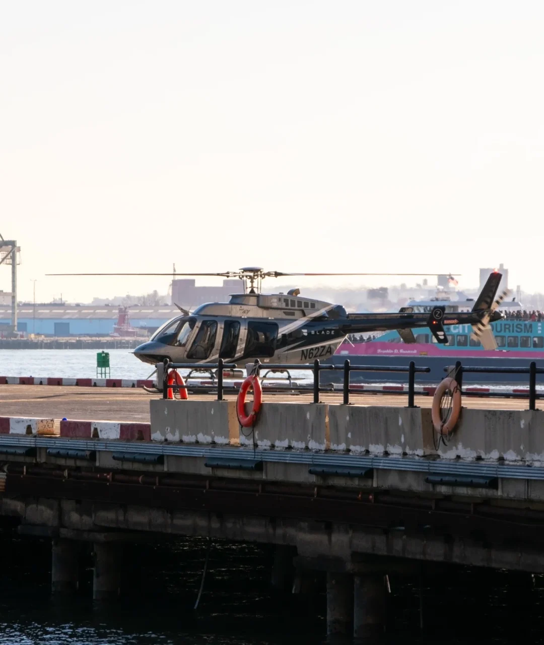 helicopter-is-parked-side-pier-with-boat-water в